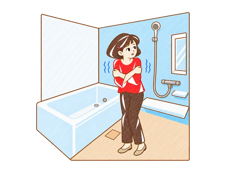 寒いお風呂で肩をすくめる人